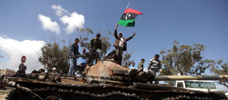 Libyan rebels wave their flag on top of
